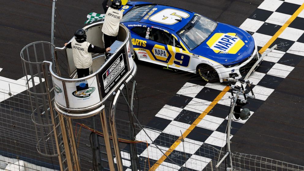 NASCAR Cup Series driver Chase Elliott (9) takes the checkered flag under a yellow caution flag at a NASCAR Cup Series auto race at Atlanta Motor Speedway in Hampton, Ga., Sunday, July 10, 2022. (AP Photo/Bob Andres)