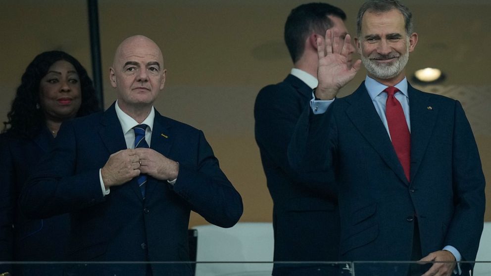 Spain's King Felipe VI, right, waves next to FIFA President Gianni Infantino during the World Cup group E soccer match between Spain and Costa Rica, at the Al Thumama Stadium in Doha, Qatar, Wednesday, Nov. 23, 2022. (AP Photo/Francisco Seco)