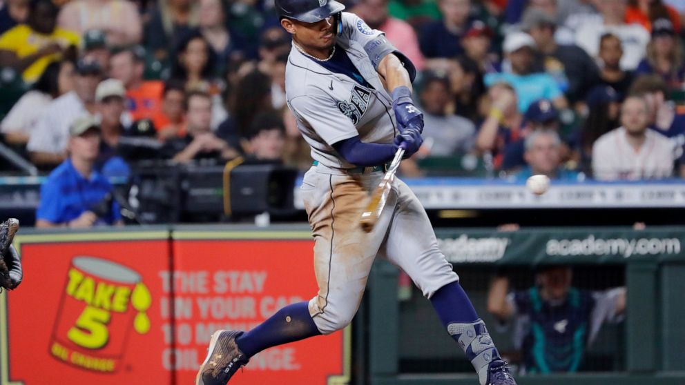 Seattle Mariners' Julio Rodriguez hits an RBI double against the Houston Astros during the eighth inning of a baseball game Friday, July 29, 2022, in Houston. (AP Photo/Michael Wyke)