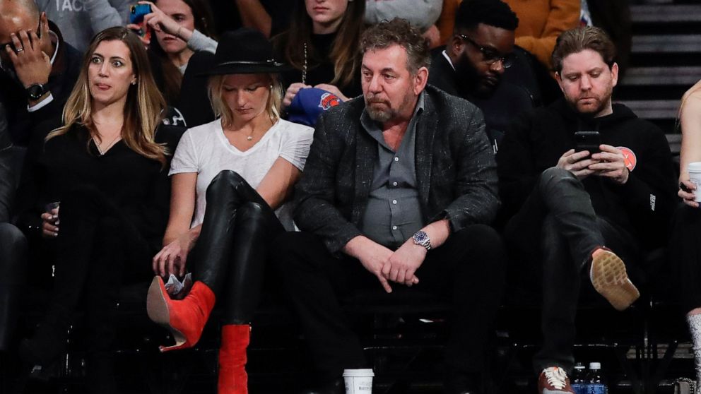 New York Knicks owner James Dolan, center, reacts with fans during the second half of the team's NBA basketball game against the Memphis Grizzlies on Wednesday, Jan. 29, 2020, in New York. The Grizzlies won 127-106. (AP Photo/Frank Franklin II)