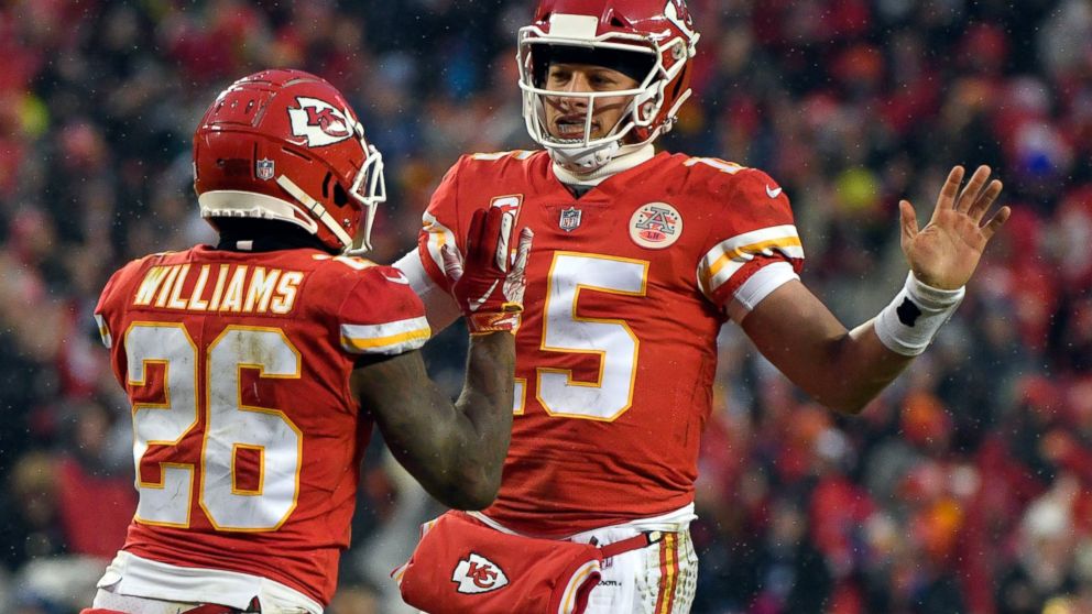 Kansas City Chiefs quarterback Patrick Mahomes (15) celebrates a touchdown with running back Damien Williams (26) during the first half of an NFL divisional football playoff game against the Indianapolis Colts in Kansas City, Mo., Saturday, Jan. 12, 