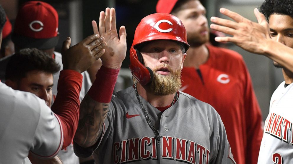 Cincinnati Reds' Jake Fraley is congratulated after he scored against the Pittsburgh Pirates during the eighth inning of a baseball game Friday, Aug. 19, 2022, in Pittsburgh. (AP Photo/Philip G. Pavely)