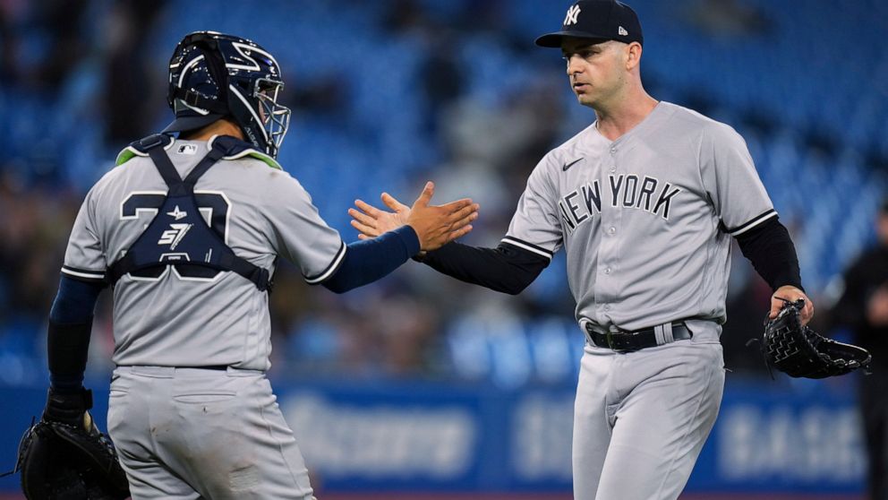 New York Yankees relief pitcher Lucas Luetge (63) celebrates with catcher Jose Trevino (39) after the team's win over the Toronto Blue Jays in a baseball game Tuesday, May 3, 2022, in Toronto. (Nathan Denette/The Canadian Press via AP)