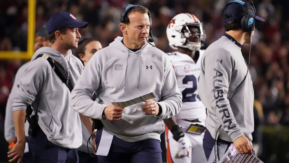 FILE - Auburn head coach Bryan Harsin walks near the sideline during a timeout in the first half of an NCAA college football game against South Carolina on Nov. 20, 2021, in Columbia, S.C. Harsin says he is “not planning on going anywhere” as he trie
