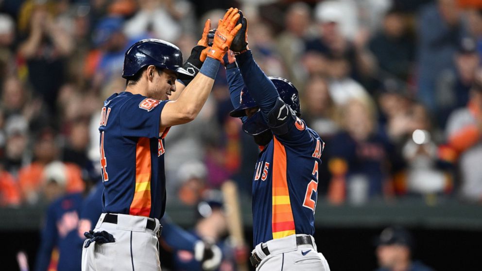 Houston Astros' Jose Altuve, right, celebrates his two-run home run with Maurico Dubon in the third inning of a baseball game against the Baltimore Orioles, Saturday, Sept. 24, 2022, in Baltimore. (AP Photo/Gail Burton)