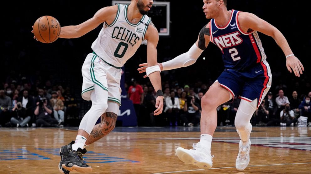 Boston Celtics forward Jayson Tatum (0) drives against Brooklyn Nets forward Blake Griffin (2) during the second half of Game 4 of an NBA basketball first-round playoff series, Monday, April 25, 2022, in New York. (AP Photo/John Minchillo)