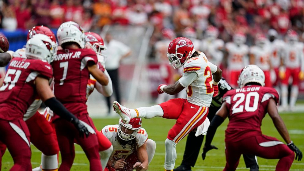 Kansas City Chiefs safety Justin Reid (20) kicks an extra point against the Arizona Cardinals during the first half of an NFL football game, Sunday, Sept. 11, 2022, in Glendale, Ariz. (AP Photo/Ross D. Franklin)