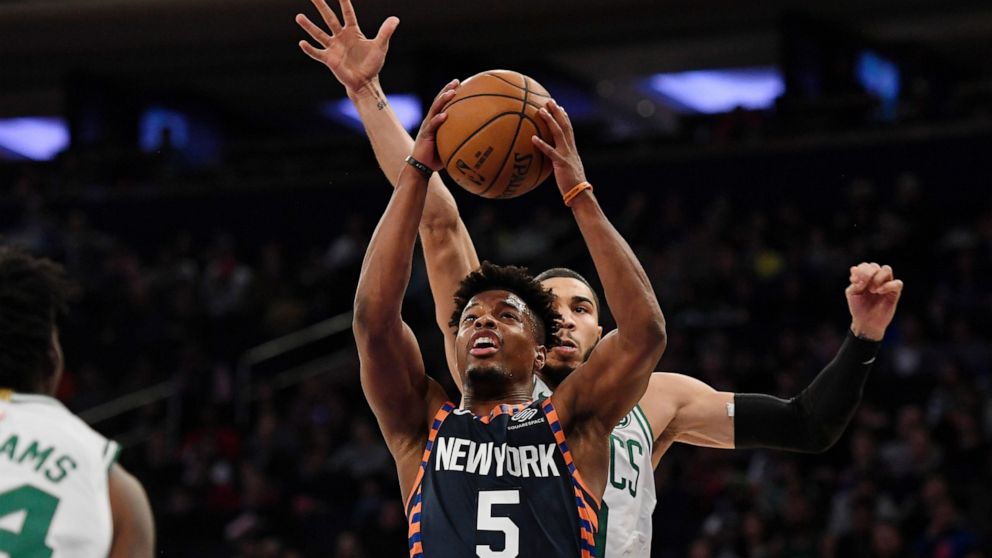 New York Knicks guard Dennis Smith Jr. (5) attempts a basket during the first half of an NBA basketball game against the Boston Celtics, Sunday, Dec. 1, 2019, in New York. (AP Photo/Sarah Stier)