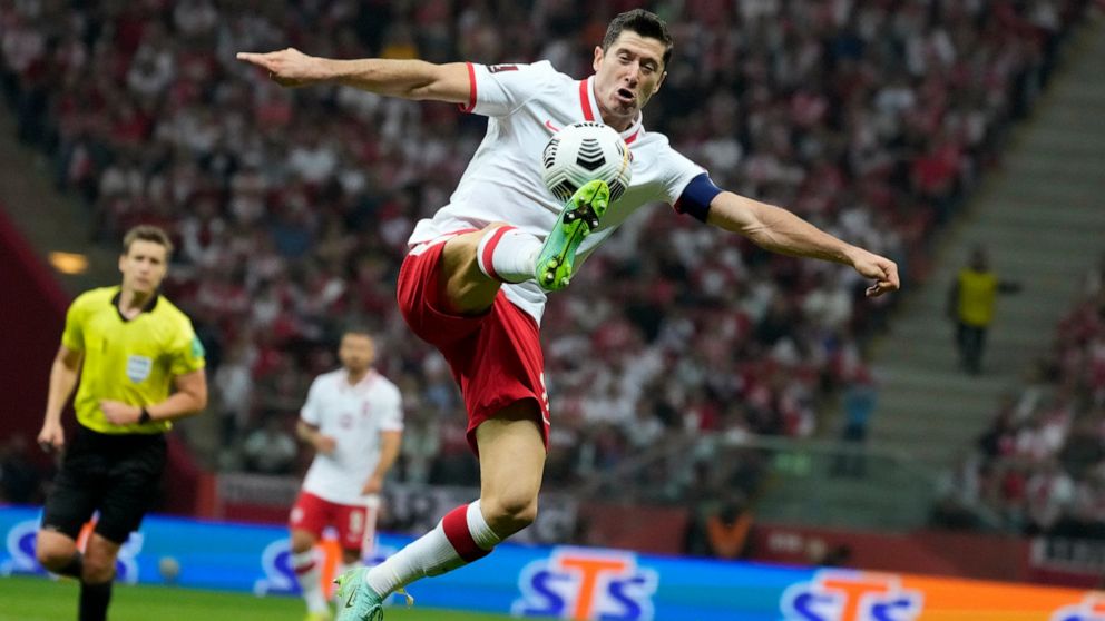 FILE - Poland's Robert Lewandowski controls the ball during the World Cup 2022 group I qualifying soccer match between Poland and England, at the Narodowy stadium in Warsaw, Wednesday, Sept. 8, 2021. Poland captain Robert Lewandowski will shoulder hi
