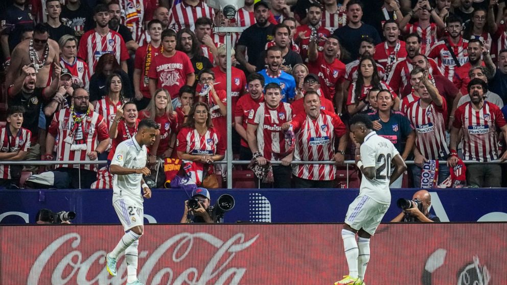FILE - Real Madrid's Rodrygo, left, celebrates after scoring with his teammate Real Madrid's Vinicius Junior the opening goal during the Spanish La Liga soccer match between Atletico Madrid and Real Madrid at the Wanda Metropolitano stadium in Madrid