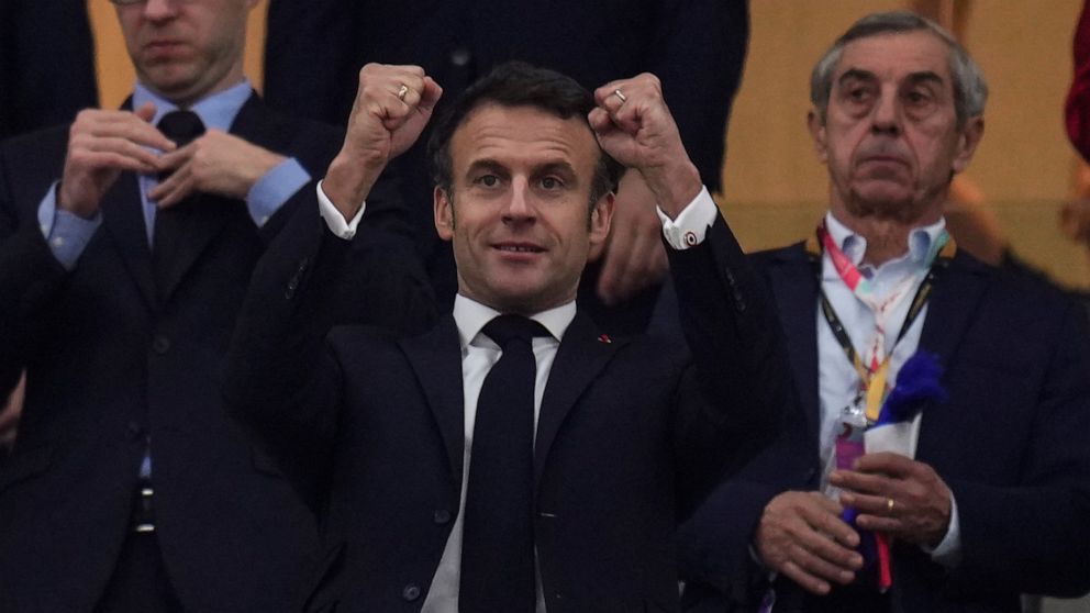 FILE - French president Emmanuel Macron gestures during the World Cup semifinal soccer match between France and Morocco at the Al Bayt Stadium in Al Khor, Qatar, on Dec. 14, 2022. Macron is about to jet off to Qatar for the second time in a week, des