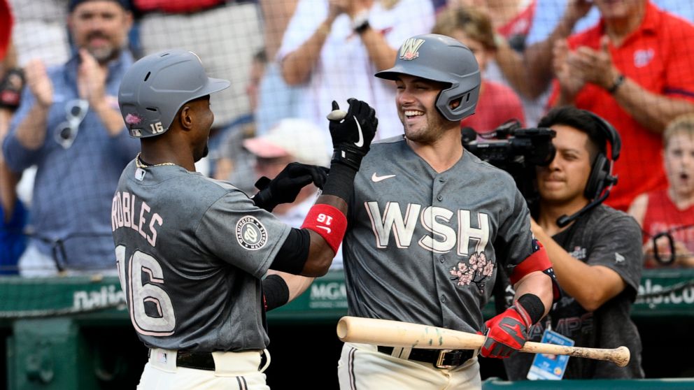 Washington Nationals' Victor Robles, left, celebrates his home run with Lane Thomas during the fourth inning of a baseball game against the Miami Marlins, Saturday, Sept. 17, 2022, in Washington. (AP Photo/Nick Wass)
