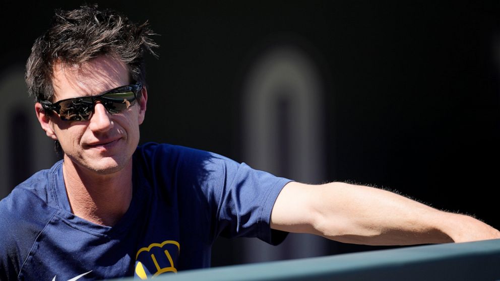 Milwaukee Brewers manager Craig Counsell looks on from the dugout as players warm up before a baseball game against the Colorado Rockies Monday, Sept. 5, 2022, in Denver. (AP Photo/David Zalubowski)