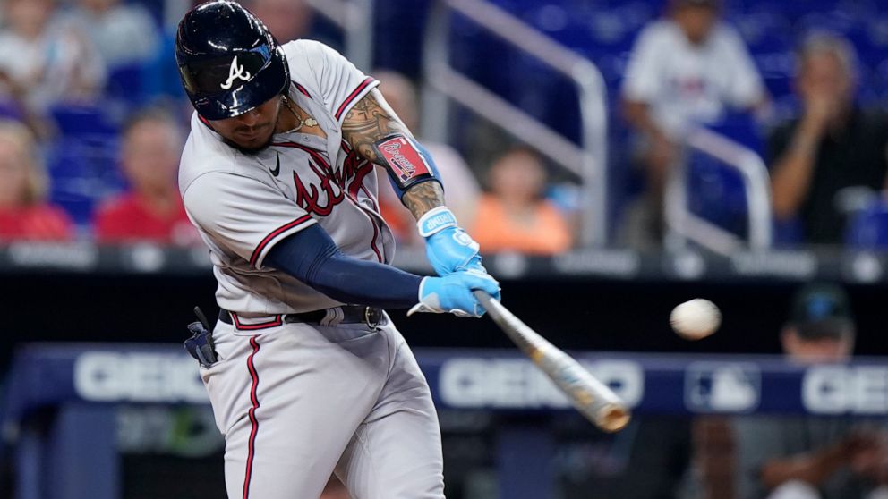 Atlanta Braves' Chadwick Tromp hits a single scoring Michael Harris II during the eighth inning of the first game of a baseball doubleheader against the Miami Marlins, Saturday, Aug. 13, 2022, in Miami. (AP Photo/Wilfredo Lee)