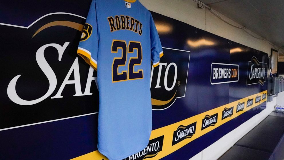 A jersey honoring 8-year-old Cooper Roberts, who was paralyzed from the waist down during a July 4 mass shooting in Highland Park, is seen in the Milwaukee Brewers dugout before a baseball game against the Pittsburgh Pirates Friday, July 8, 2022, in 