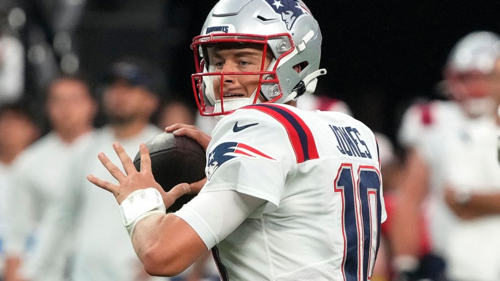 FILE - New England Patriots quarterback Mac Jones (10) throws against the Las Vegas Raiders during the first half of an NFL preseason football game, Friday, Aug. 26, 2022, in Las Vegas. Tua Tagovailoa and Mac Jones will be forever linked by their tim
