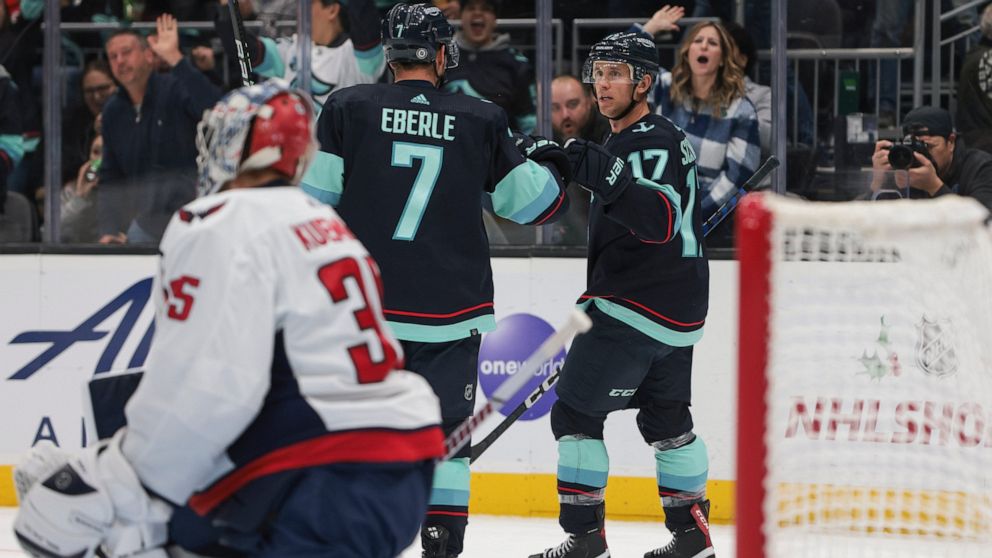 Seattle Kraken center Jaden Schwartz (17) celebrates after his goal with right wing Jordan Eberle as Washington Capitals goaltender Darcy Kuemper looks on during the second period of an NHL hockey game Thursday, Dec. 1, 2022, in Seattle. (AP Photo/Ja