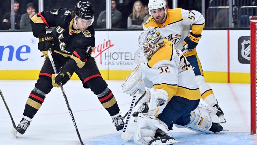 Vegas Golden Knights defenseman Ben Hutton (17) shoots against Nashville Predators goaltender Kevin Lankinen (32) during the second period of an NHL hockey game Saturday, Dec. 31, 2022, in Las Vegas. (AP Photo/David Becker)