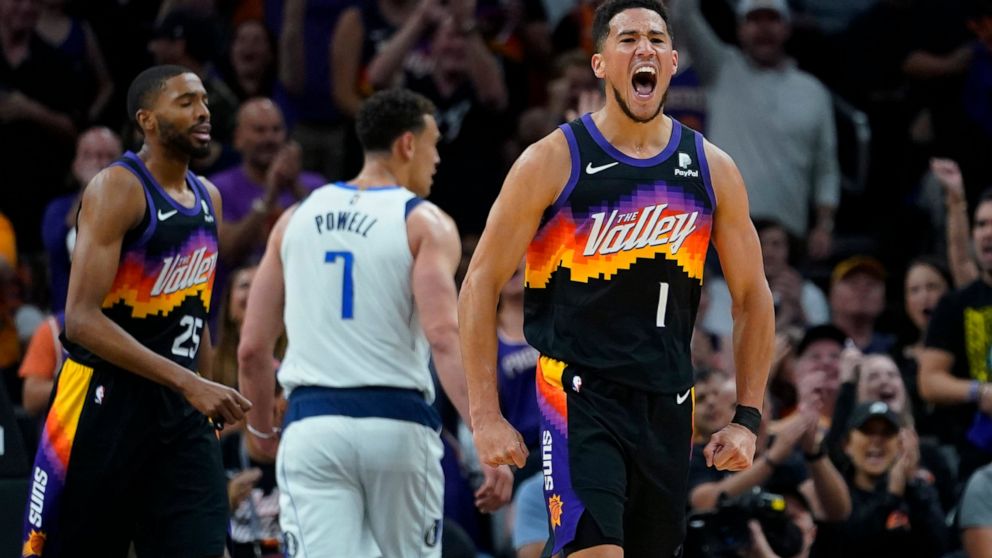 Phoenix Suns guard Devin Booker (1) celebrates a score against the Dallas Mavericks during the first half of Game 1 in the second round of the NBA Western Conference playoff series Monday, May 2, 2022, in Phoenix. (AP Photo/Matt York)