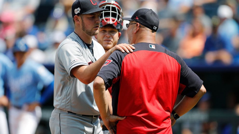 Cleveland Indians pitcher Trevor Bauer, left, reacts as he is taken out by manager Terry Francona in the fifth inning of a baseball game against the Kansas City Royals at Kauffman Stadium in Kansas City, Mo., Sunday, July 28, 2019. (AP Photo/Colin E.
