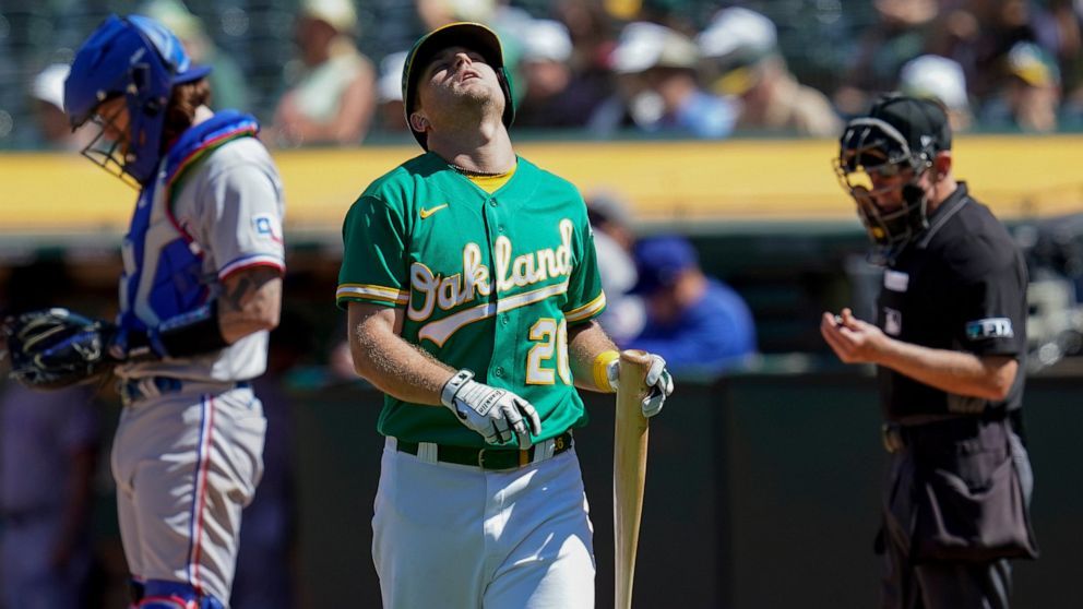 Oakland Athletics' Sheldon Neuse (26) reacts after striking out against Texas Rangers starting pitcher Martín Pérez during the seventh inning of a baseball game in Oakland, Calif., Sunday, July 24, 2022. (AP Photo/Godofredo A. Vásquez)