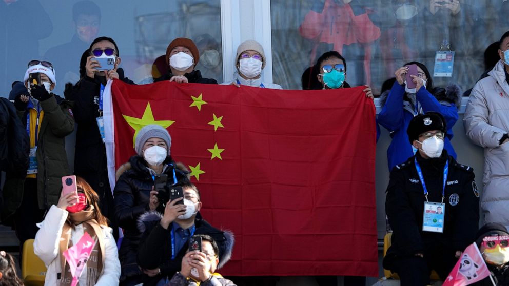Spectators wait for Eileen Gu, of China, during the women's freestyle skiing big air finals of the 2022 Winter Olympics, Tuesday, Feb. 8, 2022, in Beijing. (AP Photo/Jae C. Hong)