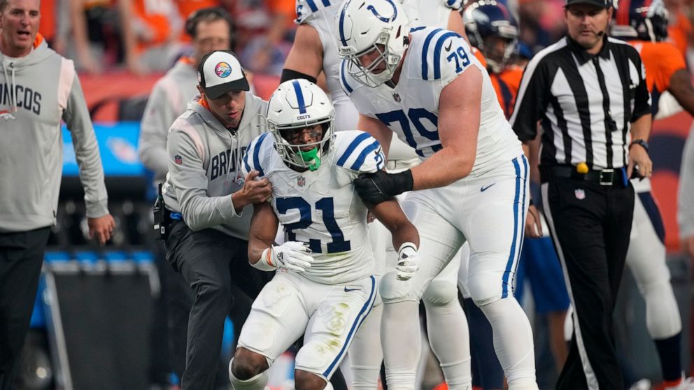 Indianapolis Colts running back Nyheim Hines (21) stumbles as he tries to get up after being injured against the Denver Broncos during the first half of an NFL football game, Thursday, Oct. 6, 2022, in Denver. (AP Photo/David Zalubowski)