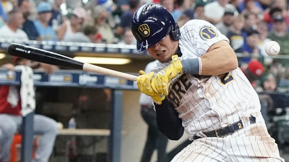 Milwaukee Brewers' Luis Uria is hit by a pitch during the seventh inning of a baseball game against the Cincinnati Reds Sunday, Aug. 7, 2022, in Milwaukee. (AP Photo/Morry Gash)