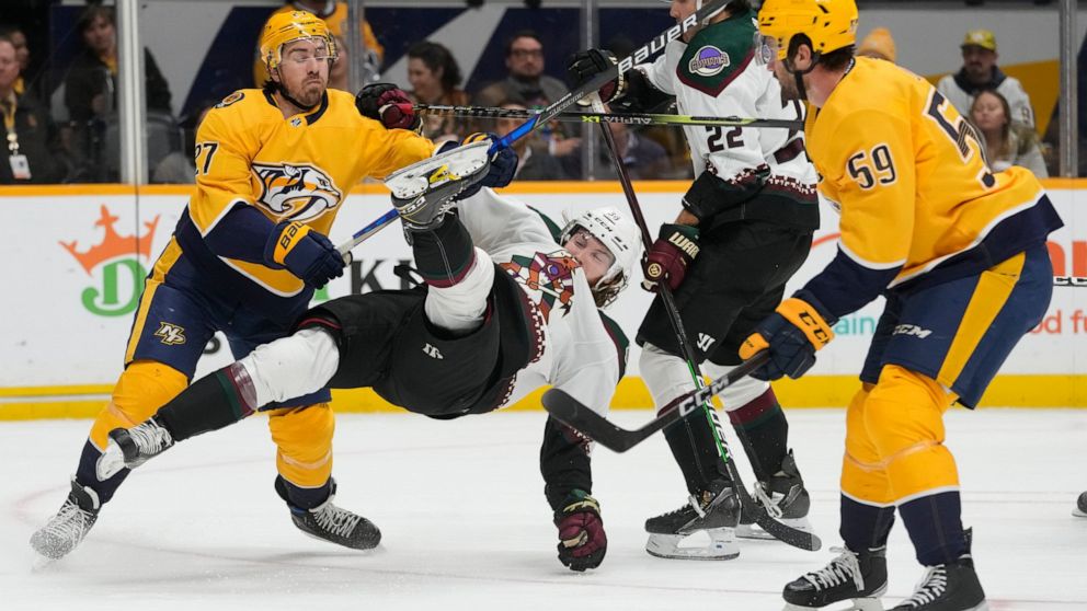 Nashville Predators' Ryan McDonagh (27) checks Arizona Coyotes' Liam O'Brien (38) to the ice in the first period of an NHL hockey game Monday, Nov. 21, 2022, in Nashville, Tenn. (AP Photo/Mark Humphrey)