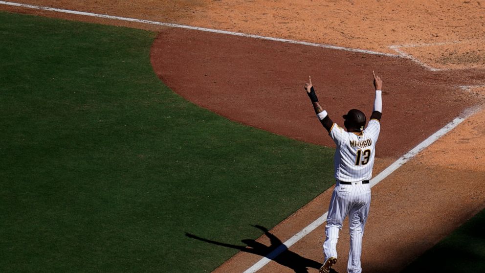 San Diego Padres' Manny Machado reacts as he scores from third off a three-run home run hit by Brandon Drury during the sixth inning of a baseball game against the San Francisco Giants, Wednesday, Aug. 10, 2022, in San Diego. (AP Photo/Gregory Bull)