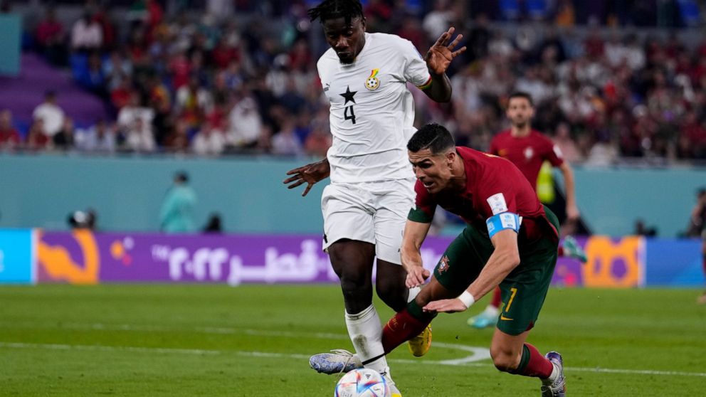 Ghana's Mohammed Salisu fouls in the penalty box Portugal's Cristiano Ronaldo during a World Cup group H soccer match at the Stadium 974 in Doha, Qatar, Thursday, Nov. 24, 2022. (AP Photo/Manu Fernandez)