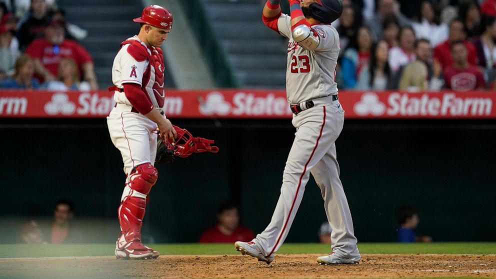 Washington Nationals designated hitter Nelson Cruz (23) points to the sky as he crosses home plate after hitting a home run during the fifth inning of a baseball game against the Los Angeles Angels in Anaheim, Calif., Saturday, May 7, 2022. Josh Bell