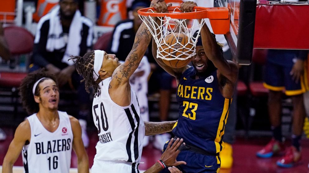 Indiana Pacers' Isaiah Jackson dunks against Portland Trail Blazers' Michael Beasley during the first half of an NBA summer league basketball game Thursday, Aug. 12, 2021, in Las Vegas. (AP Photo/John Locher)