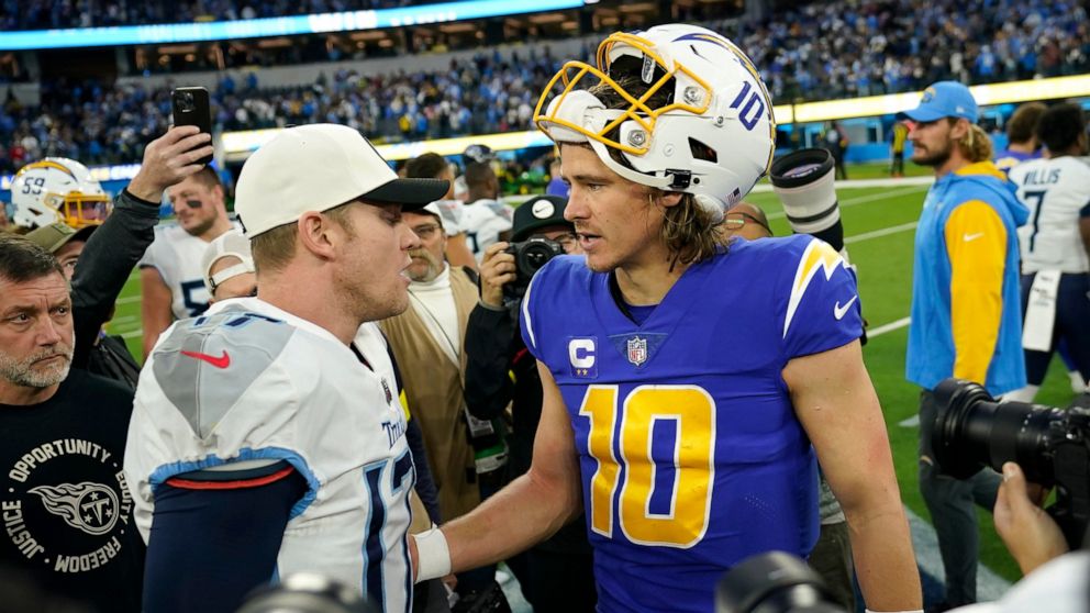 Tennessee Titans quarterback Ryan Tannehill, left, greets Los Angeles Chargers quarterback Justin Herbert (10) after an NFL football game in Inglewood, Calif., Sunday, Dec. 18, 2022. (AP Photo/Ashley Landis)