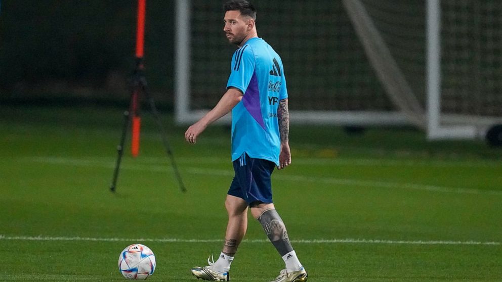 Lionel Messi walks the field during a training session of Argentina's national soccer team in Doha, Saturday, Nov. 19, 2022. (AP Photo/Jorge Saenz)