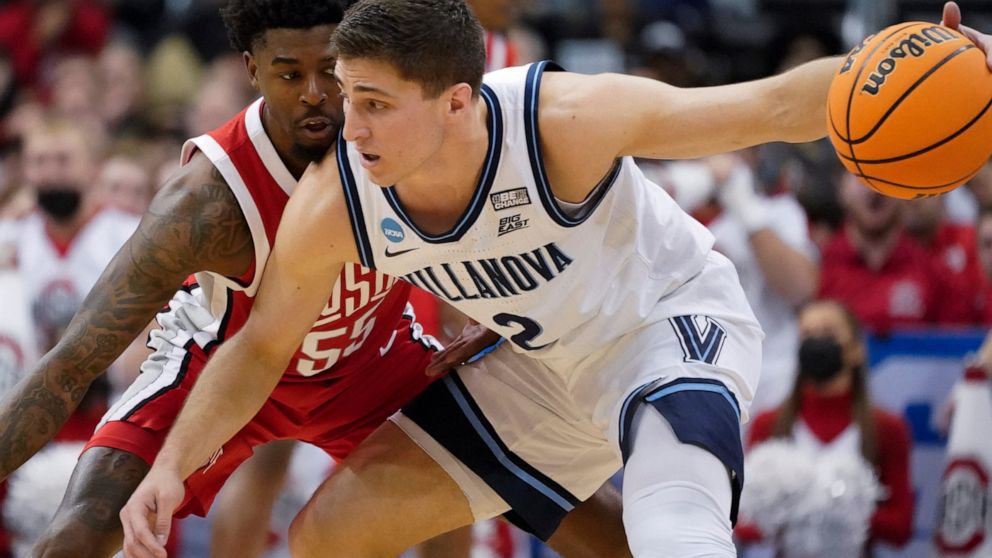 Villanova's Collin Gillespie (2) tries to get the ball past Ohio State's Jamari Wheeler (55) during the first half of a college basketball game in the second round of the NCAA tournament, Sunday, March 20, 2022, in Pittsburgh. (AP Photo/Keith Srakocic)