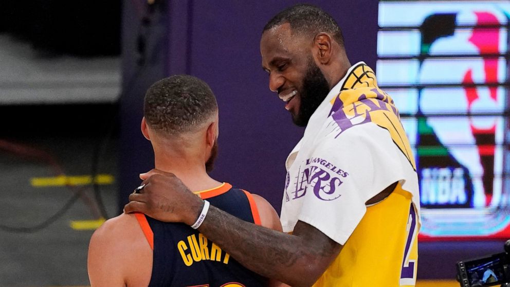 Los Angeles Lakers forward LeBron James, right, greets Golden State Warriors guard Stephen Curry after the Lakers defeated the Golden State Warriors 103-100 in an NBA basketball Western Conference Play-In game Wednesday, May 19, 2021, in Los Angeles.