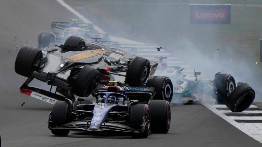 Alfa Romeo driver Guanyu Zhou of China crashes at the start of the British Formula One Grand Prix at the Silverstone circuit, in Silverstone, England, Sunday, July 3, 2022. (AP Photo/Frank Augstein)