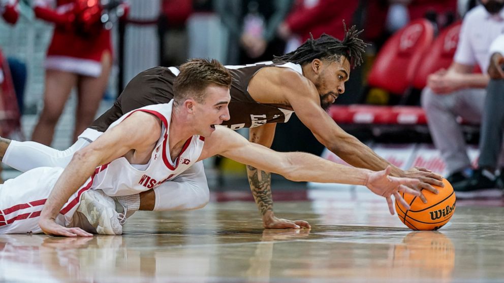 Wisconsin's Tyler Wahl (5) and Lehigh's Jalin Sinclair (55) dive after a loose ball during the first half of an NCAA college basketball game Thursday, Dec. 15, 2022, in Madison, Wis. (AP Photo/Andy Manis)