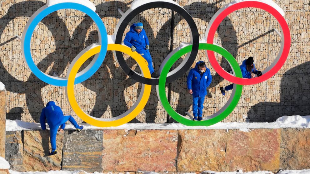 Ukraine team members climb on the Olympic Rings to pose for photo in the Olympic Village at the 2022 Winter Olympics, Monday, Feb. 14, 2022, in the Yanqing district of Beijing. Backers of Sapporo, Japan, to hold the 2030 Winter Olympics have gotten t