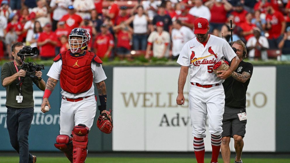 St. Louis Cardinals' Yadier Molina, left, and Adam Wainwright walk in from the bullpen after warming up for the team's baseball game against the Milwaukee Brewers on Wednesday Sept. 14, 2022, in St. Louis. (AP Photo/Joe Puetz)