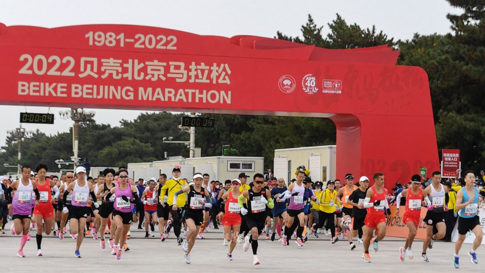 In this photo released by Xinhua News Agency, runners start to compete in the Beijing Marathon in Beijing, Sunday, Nov. 6, 2022. Thousands of runners took to the streets of China's capital on Sunday for the return of the Beijing marathon after a two-