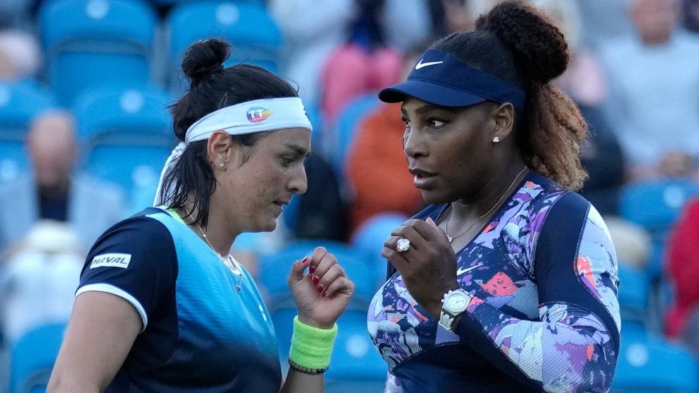 Serena Williams of the United States and Ons Jabeur of Tunisia speak before playing a point against Shuko Aoyama of Japan and Hao-Ching of Taiwan during their quarterfinal doubles tennis match at the Eastbourne International tennis tournament in East
