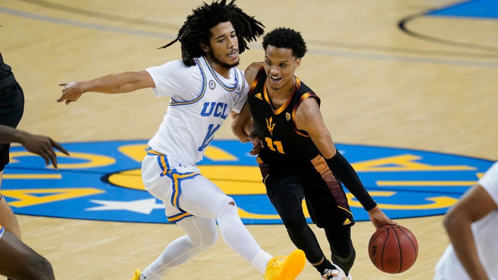 UCLA guard Tyger Campbell (10) defends against Arizona State guard Alonzo Verge Jr. (11) during the first half of an NCAA college basketball game Saturday, Feb. 20, 2021, in Los Angeles. (AP Photo/Ashley Landis)
