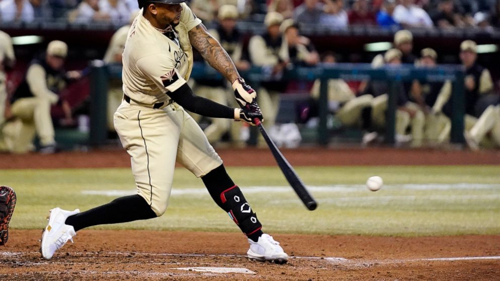Arizona Diamondbacks' Ketel Marte connects for a run-scoring double against the Chicago Cubs during the third inning of a baseball game Friday, May 13, 2022, in Phoenix. (AP Photo/Ross D. Franklin)