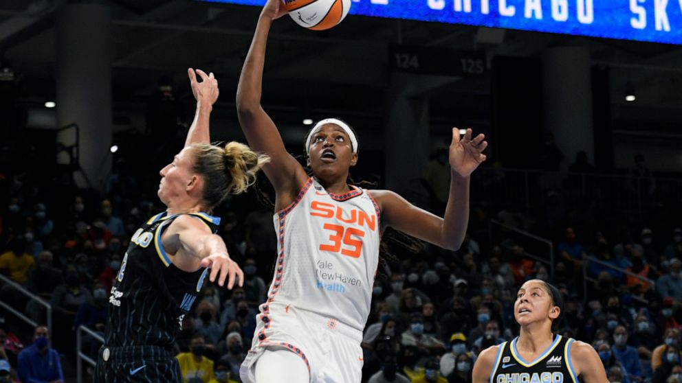 FILE - Connecticut Sun's Jonquel Jones (35) goes up for a shot against Chicago Sky's Courtney Vandersloot (22) and Candace Parker right, during the second half of Game 4 of a WNBA basketball playoff semifinal, Wednesday, Oct. 6, 2021, in Chicago. Jon