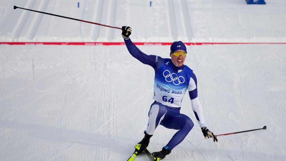 Iivo Niskanen, of Finland, reacts after crossing the finish line during the men's 15km classic cross-country skiing competition at the 2022 Winter Olympics, Friday, Feb. 11, 2022, in Zhangjiakou, China. (AP Photo/Aaron Favila)