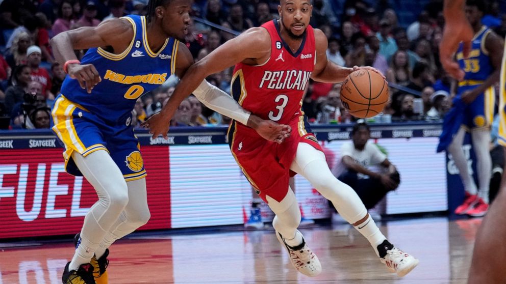 New Orleans Pelicans guard CJ McCollum (3) drives to the basket against Golden State Warriors forward Jonathan Kuminga in the first half of an NBA basketball game in New Orleans, Friday, Nov. 4, 2022. (AP Photo/Gerald Herbert)