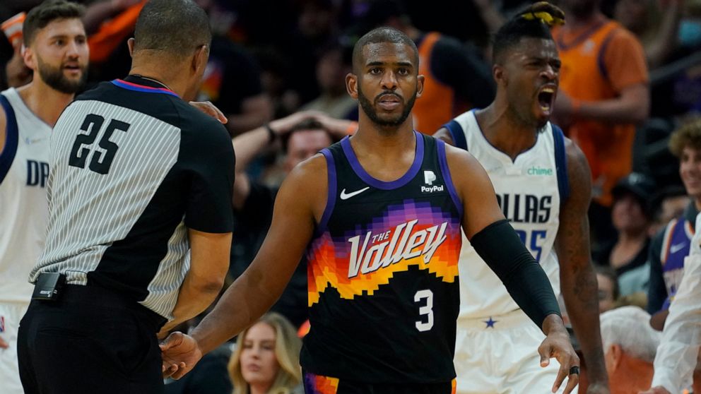 Phoenix Suns guard Chris Paul (3) and Dallas Mavericks forward Reggie Bullock, right, react after Paul was called for a foul during the first half of Game 2 of an NBA basketball second round playoff series, Wednesday, May 4, 2022, in Phoenix. (AP Pho