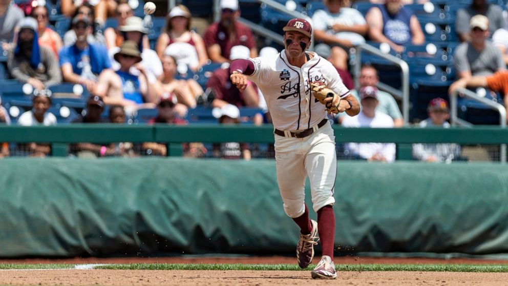 Texas A&M third baseman Trevor Werner throws to first for an out against Texas in the first inning during an NCAA College World Series baseball game Sunday, June 19, 2022, in Omaha, Neb. (AP Photo/John Peterson)